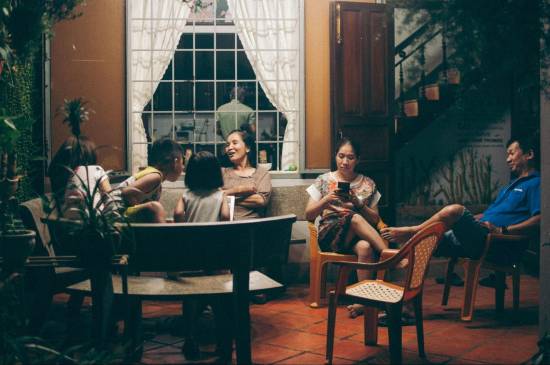 Family relaxing together on a home patio in the evening
